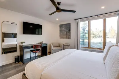 a bedroom with a large bed with a ceiling fan at Family-Friendly Condo with Mtn Views in Keystone! in Keystone