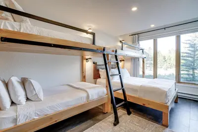 two bunk beds in a room with a window at Family-Friendly Condo with Mtn Views in Keystone! in Keystone