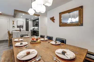 a dining room and kitchen with a table and chairs at Family-Friendly Condo with Mtn Views in Keystone! in Keystone