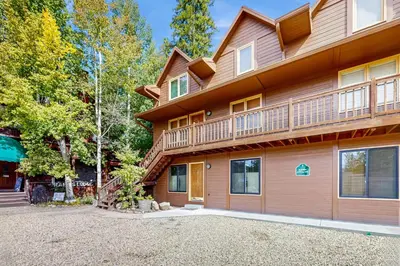 a house with a balcony on the side of it at On the Rapids in Grand Lake