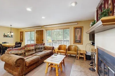 a living room with a couch and a table at On the Rapids in Grand Lake