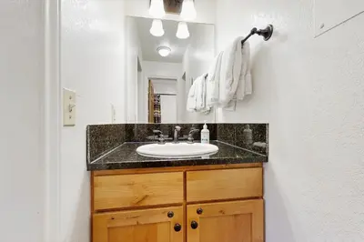 a bathroom with a sink and a mirror at On the Rapids in Grand Lake
