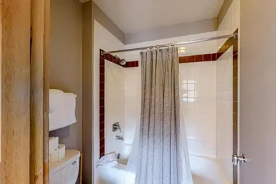 a bathroom with a shower curtain and a tub at 2 Bedroom Montezuma Condo At Lakeside Village - Shuttle To Slopes! in Keystone