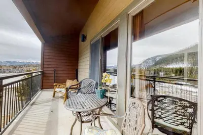 a balcony with a table and chairs on a balcony at 2 Bedroom Montezuma Condo At Lakeside Village - Shuttle To Slopes! in Keystone