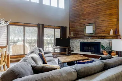 a living room with a couch and a fireplace at 2 Bedroom Montezuma Condo At Lakeside Village - Shuttle To Slopes! in Keystone