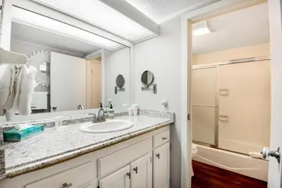 a bathroom with a sink and a mirror and a tub at Remodeled And Oversized 2-Bedroom Condo In West Keystone With Mountain Views, Pool, Hot Tub & Shuttle To Slopes! in Keystone