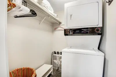 a small kitchen with a white refrigerator in a room at Remodeled And Oversized 2-Bedroom Condo In West Keystone With Mountain Views, Pool, Hot Tub & Shuttle To Slopes! in Keystone