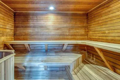 an empty sauna with wooden walls and wooden floors at Remodeled And Oversized 2-Bedroom Condo In West Keystone With Mountain Views, Pool, Hot Tub & Shuttle To Slopes! in Keystone
