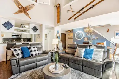 a living room with two couches and a table at Remodeled And Oversized 2-Bedroom Condo In West Keystone With Mountain Views, Pool, Hot Tub & Shuttle To Slopes! in Keystone