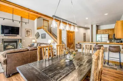 a kitchen and living room with a table and a couch at Lovely Townhome A Half-Mile From Keystone Gondola Wshared Hot-Tub & Excellent Views in Dillon