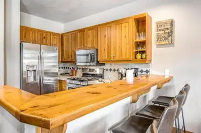 a kitchen with a wooden counter top and stainless steel appliances at Lovely Townhome A Half-Mile From Keystone Gondola Wshared Hot-Tub & Excellent Views in Dillon