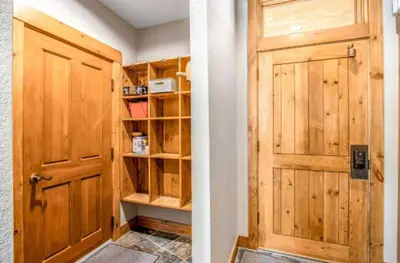 a room with a wooden door and a shelf at Lovely Townhome A Half-Mile From Keystone Gondola Wshared Hot-Tub & Excellent Views in Dillon