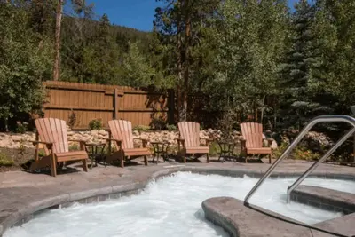 a group of chairs sitting around a swimming pool at Lovely Townhome A Half-Mile From Keystone Gondola Wshared Hot-Tub & Excellent Views in Dillon
