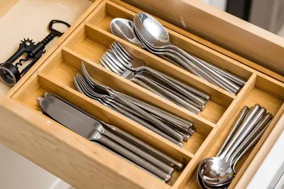 a wooden drawer with silver utensils in it at Wild West Disco Haus 2! New Hot Tub, Patio + Gym in Denver