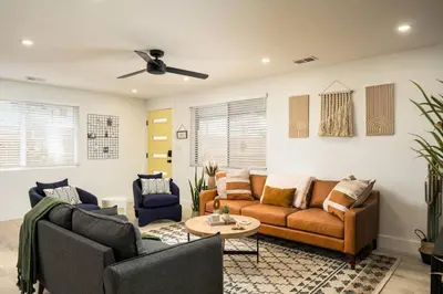 a living room with a couch and two chairs at Wild West Disco Haus! New Hot Tub, Patio + Gym in Denver