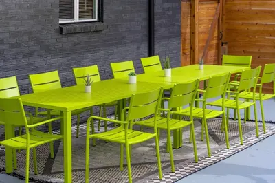 a yellow table and yellow chairs on a patio at Wild West Disco Haus! New Hot Tub, Patio + Gym in Denver