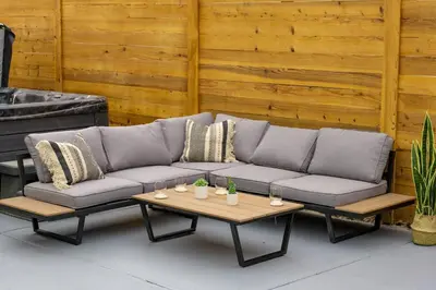 a couch and a coffee table on a patio at Wild West Disco Haus! New Hot Tub, Patio + Gym in Denver