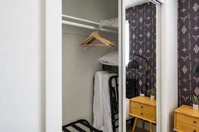a closet with a mirror in a room at Wild West Disco Haus! New Hot Tub, Patio + Gym in Denver