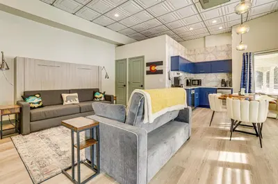 a living room with a couch and a kitchen at Keystone Lake Haven Heated Pool and Ski Shuttle! in Keystone