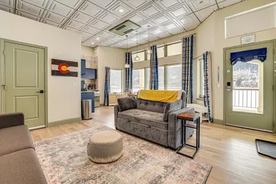 a living room with a couch and a rug at Keystone Lake Haven Heated Pool and Ski Shuttle! in Keystone