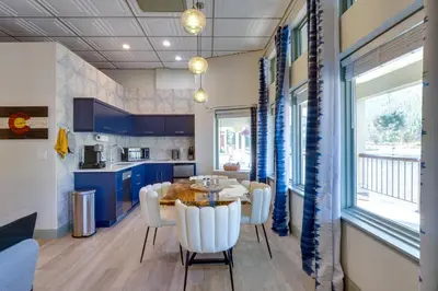 a kitchen with blue cabinets and a table and chairs at Keystone Lake Haven Heated Pool and Ski Shuttle! in Keystone