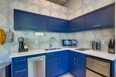 a blue kitchen with a sink and a dishwasher at Keystone Lake Haven Heated Pool and Ski Shuttle! in Keystone