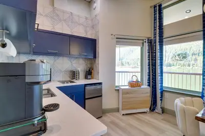 a kitchen with blue cabinets and a counter top at Keystone Lake Haven Heated Pool and Ski Shuttle! in Keystone