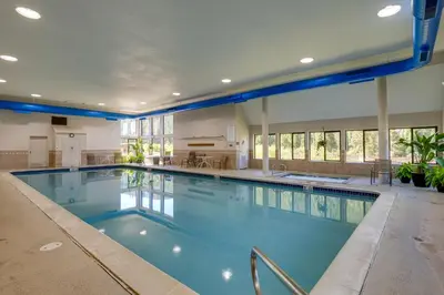 a large swimming pool with blue water in a building at Keystone Lake Haven Heated Pool and Ski Shuttle! in Keystone