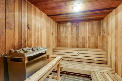 a wooden sauna with a bench in the middle at Keystone Lake Haven Heated Pool and Ski Shuttle! in Keystone
