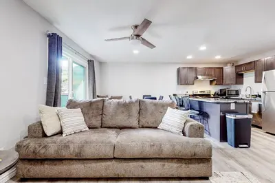 a living room with a couch and a kitchen at Cozy Colorado Condo in Dillon