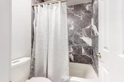 a bathroom with a shower curtain and a toilet at Cozy Colorado Condo in Dillon
