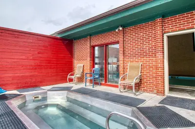 a swimming pool in front of a brick building at Cozy Colorado Condo in Dillon