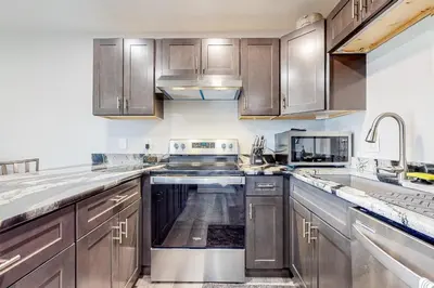 a kitchen with wooden cabinets and stainless steel appliances at Cozy Colorado Condo in Dillon