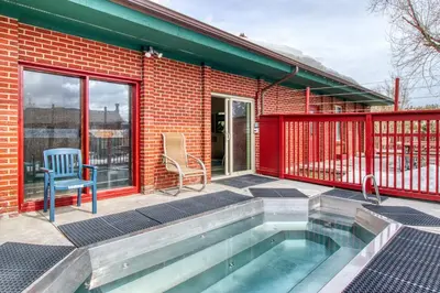 a house with a swimming pool in front of a building at Cozy Colorado Condo in Dillon
