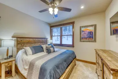 a bedroom with a bed and a ceiling fan at The Alders Townhomes In East Keystone - Luxury 3 Bedroom Den in Keystone
