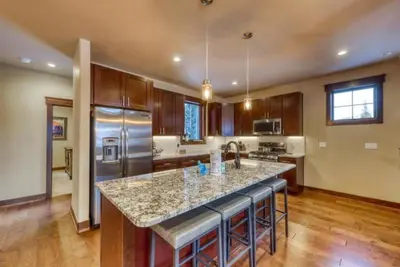 a kitchen with a large island in the middle at The Alders Townhomes In East Keystone - Luxury 3 Bedroom Den in Keystone