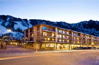 a large building with cars parked in a parking lot at The Alders Townhomes In East Keystone - Luxury 3 Bedroom Den in Keystone