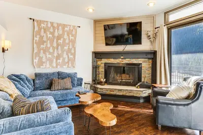 a living room with blue couches and a fireplace at 1 Mi to Keystone Resort Mtn-View Family Escape! in Keystone