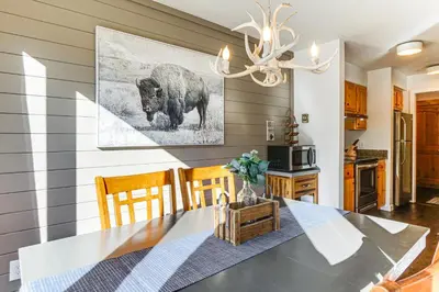 a dining room with a table with a buffalo picture on the wall at 1 Mi to Keystone Resort Mtn-View Family Escape! in Keystone
