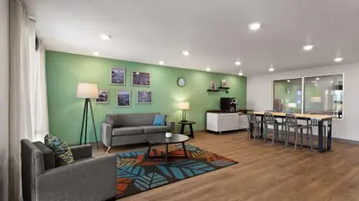 a living room with a couch and a table at WoodSpring Suites Greeley in Greeley