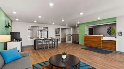 a living room with a couch and a table at WoodSpring Suites Greeley in Greeley