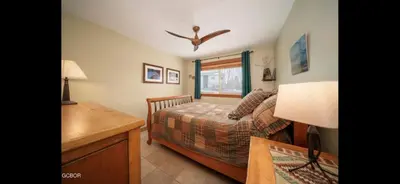 a bedroom with a bed and a desk and a window at Riverside Retreat in Funky Fraser on Train, Bike and Bus Routes in Fraser
