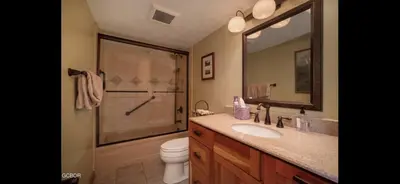a bathroom with a shower and a toilet and a sink at Riverside Retreat in Funky Fraser on Train, Bike and Bus Routes in Fraser