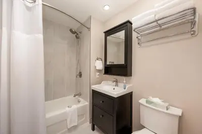 a bathroom with a sink and a tub and a toilet at Ski-In/Ski-Out Zephyr 1 Bedroom Condo Winter Park in Winter Park