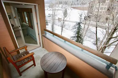 a room with a window with a table and a chair at Ski-In/Ski-Out Zephyr 1 Bedroom Condo Winter Park in Winter Park