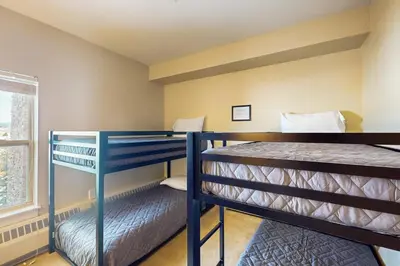 two bunk beds in a room with a window at 310 Base Camp in Granby