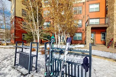 a bench with skis and skis in the snow at 310 Base Camp in Granby