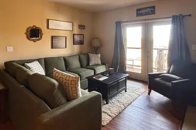 a living room with a couch and a table at 310 Base Camp in Granby