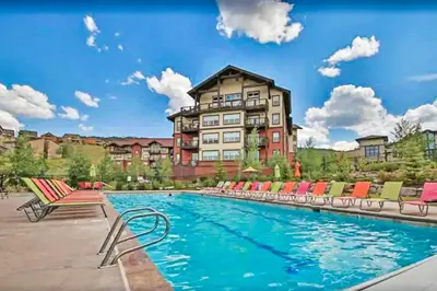 a hotel with a swimming pool in front of a building at 310 Base Camp in Granby