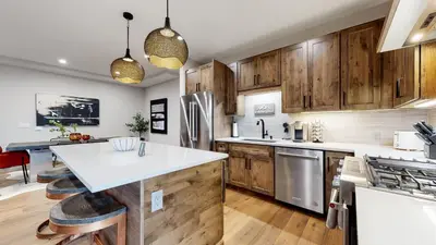 a kitchen with wooden cabinets and a white counter top at Winter Park Condo w/Hot Tub & 4 Mi to Skiing in Winter Park